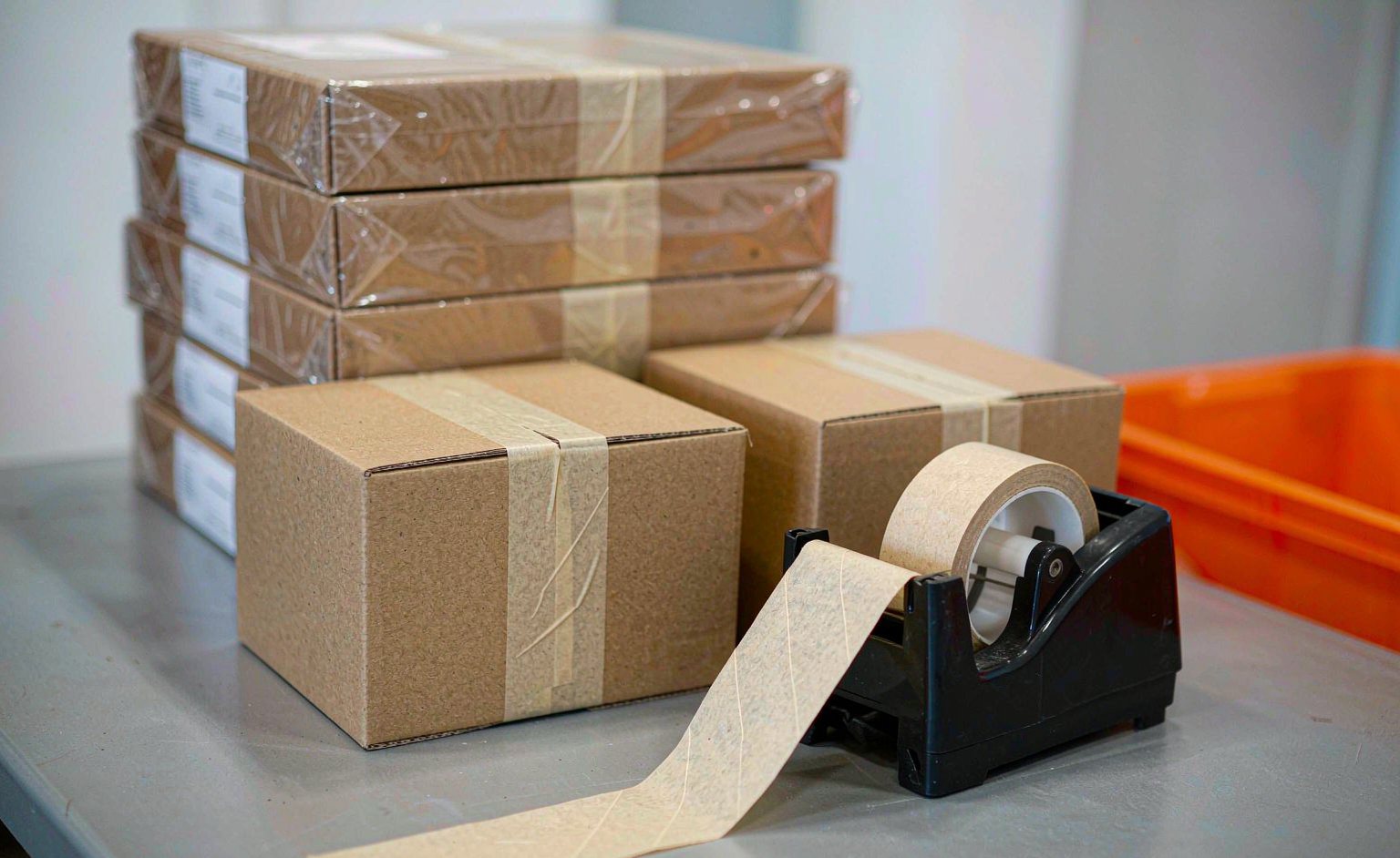 Flat-packed furniture cartons sealed and labeled at a packing station